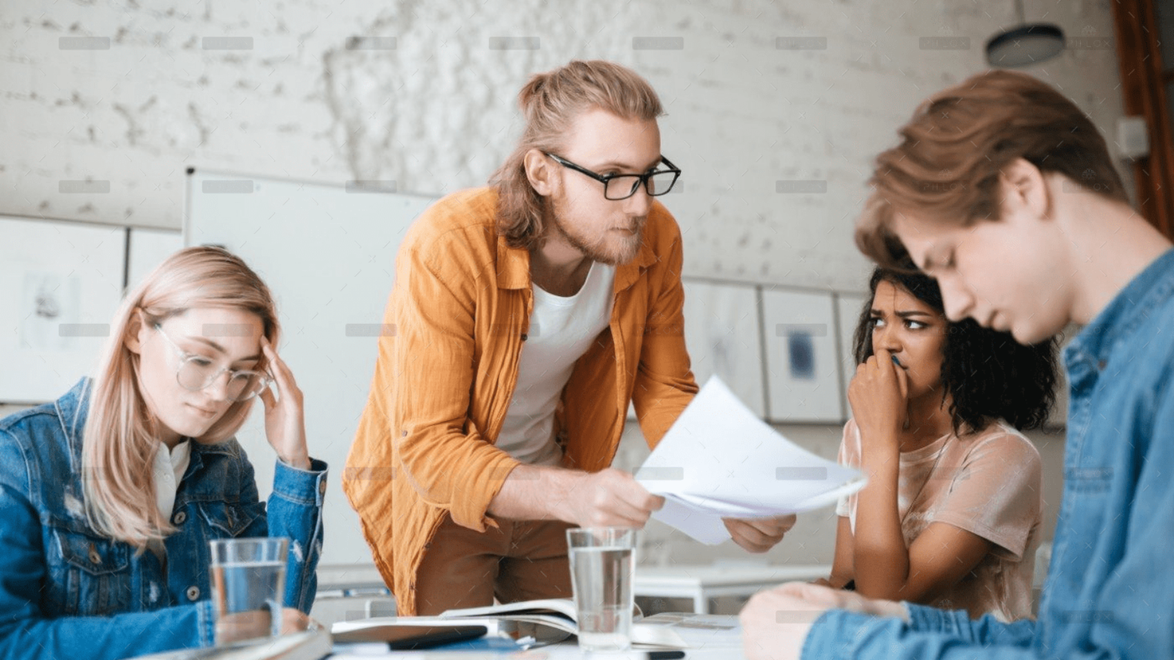 demo-attachment-292-group-of-upset-students-sitting-at-the-table-with-E5YW9L4