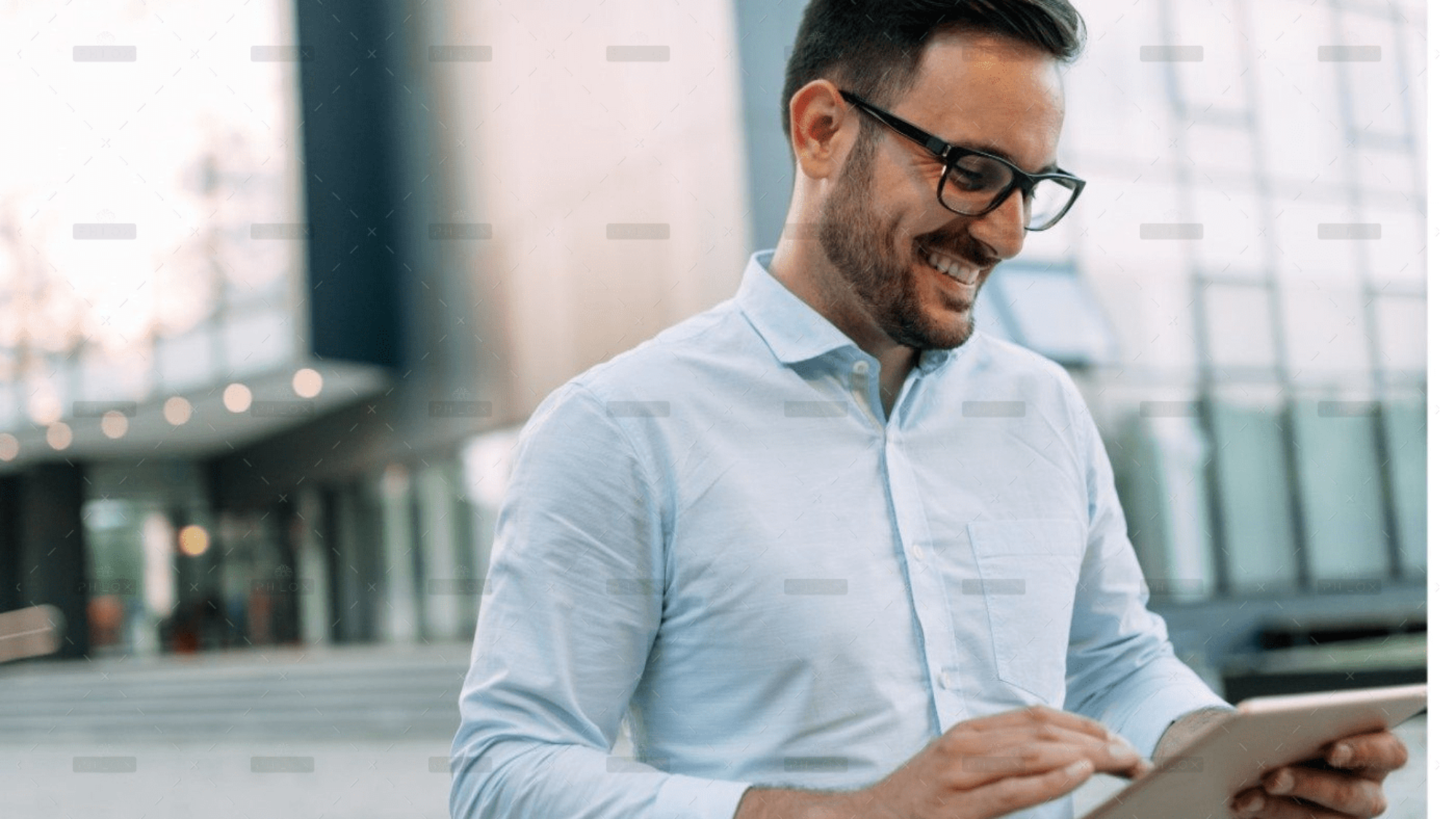 demo-attachment-609-portrait-of-businessman-in-glasses-holding-tablet-AWVHCJU